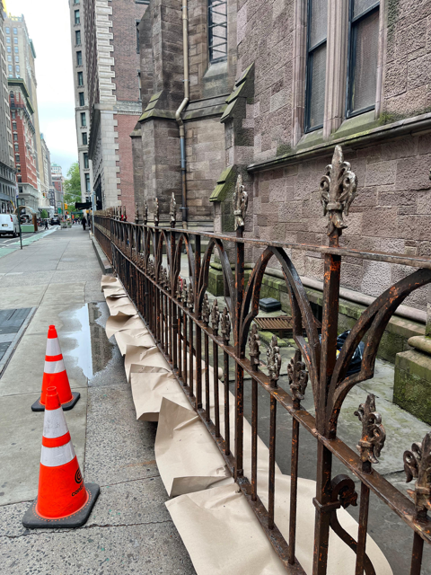 Sanding the Rusted Fence Around the Cathedral